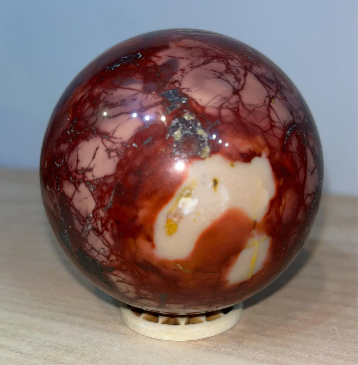 Mookaite crystal sphere with wooden stand