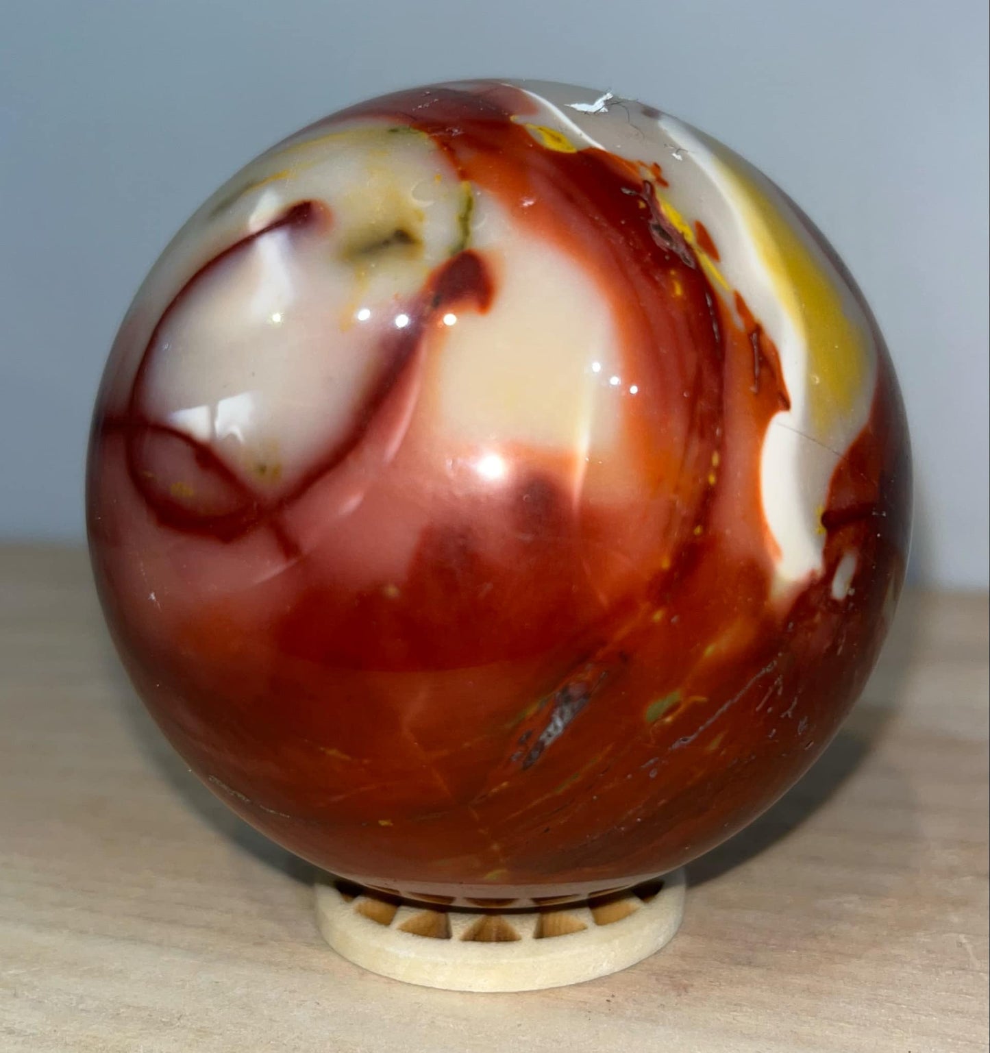 Mookaite crystal sphere with wooden stand