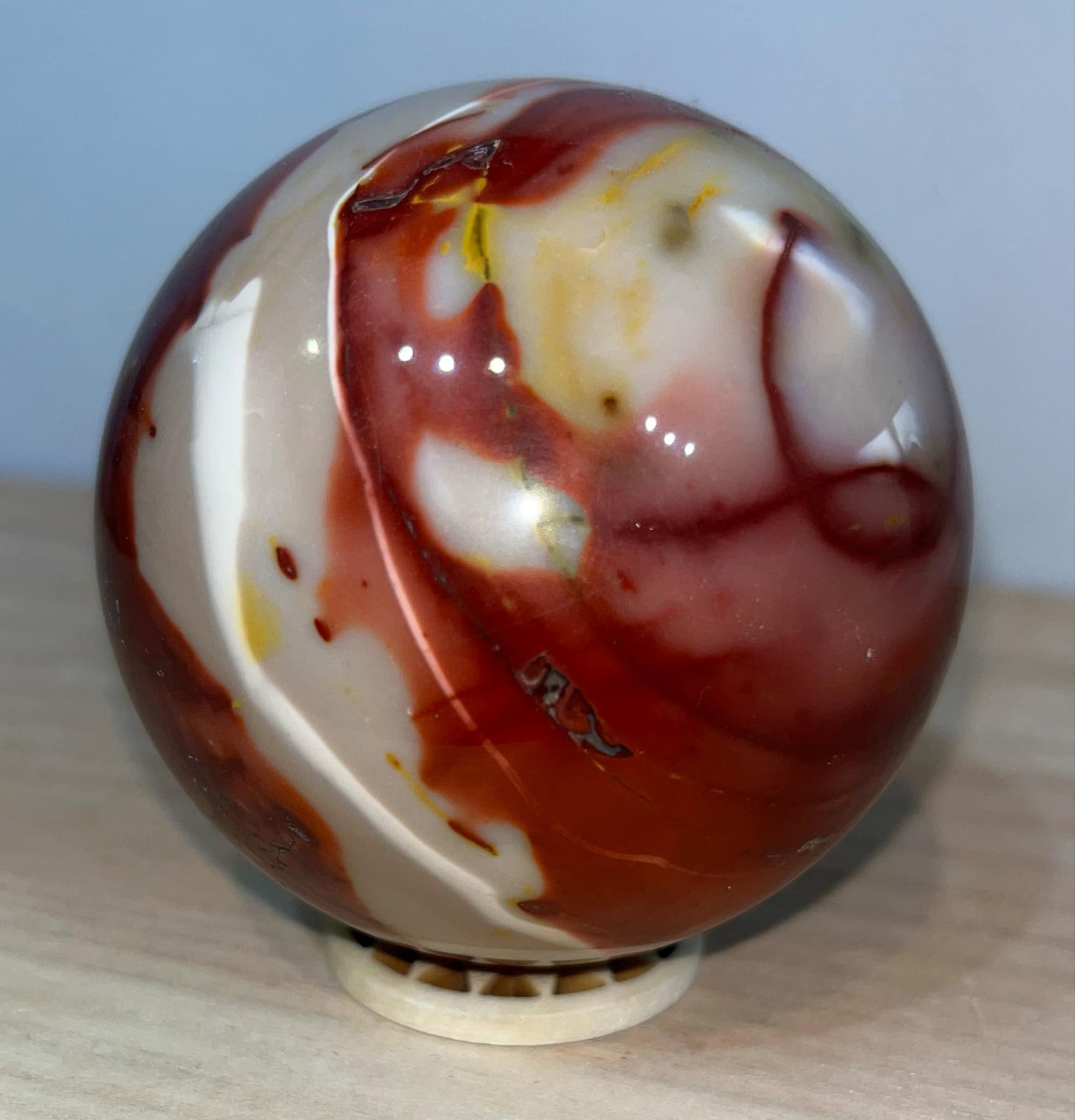 Mookaite crystal sphere with wooden stand